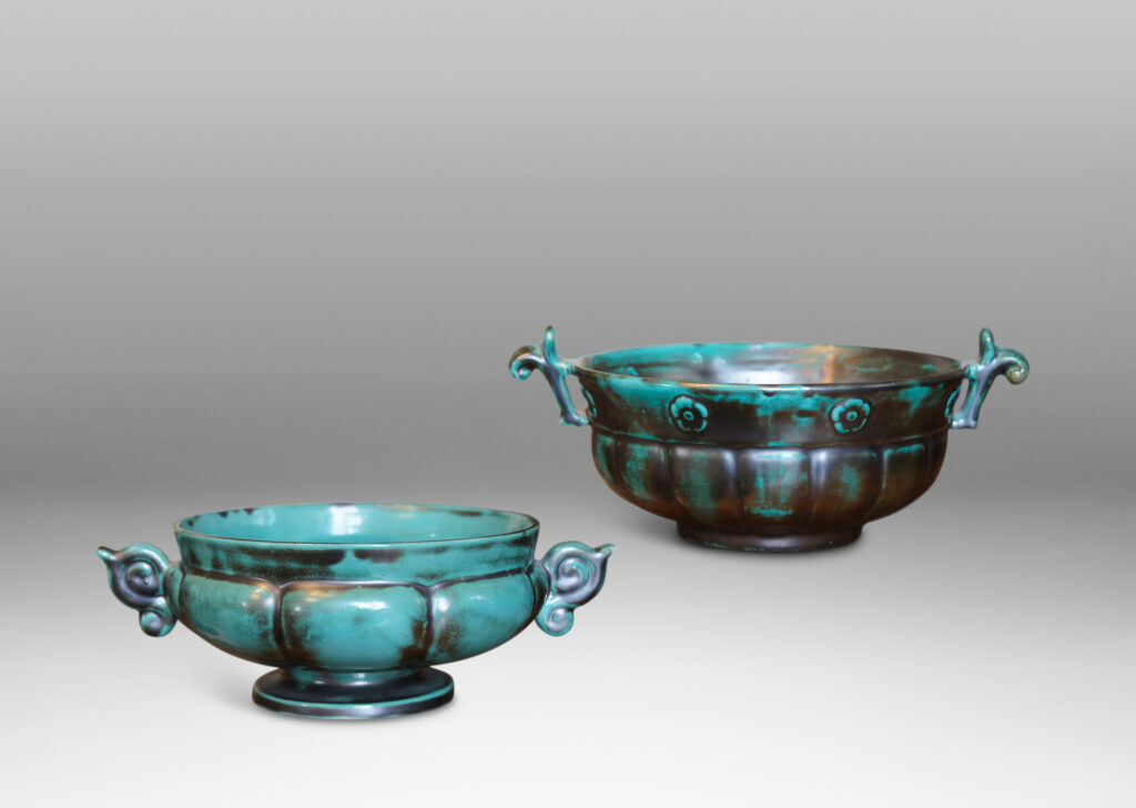 Gallery BAC blend of Viking, Chinese, and Art Deco influences, having wide lobed forms on small plinths and handles, faience with an aqua-green copper glaze