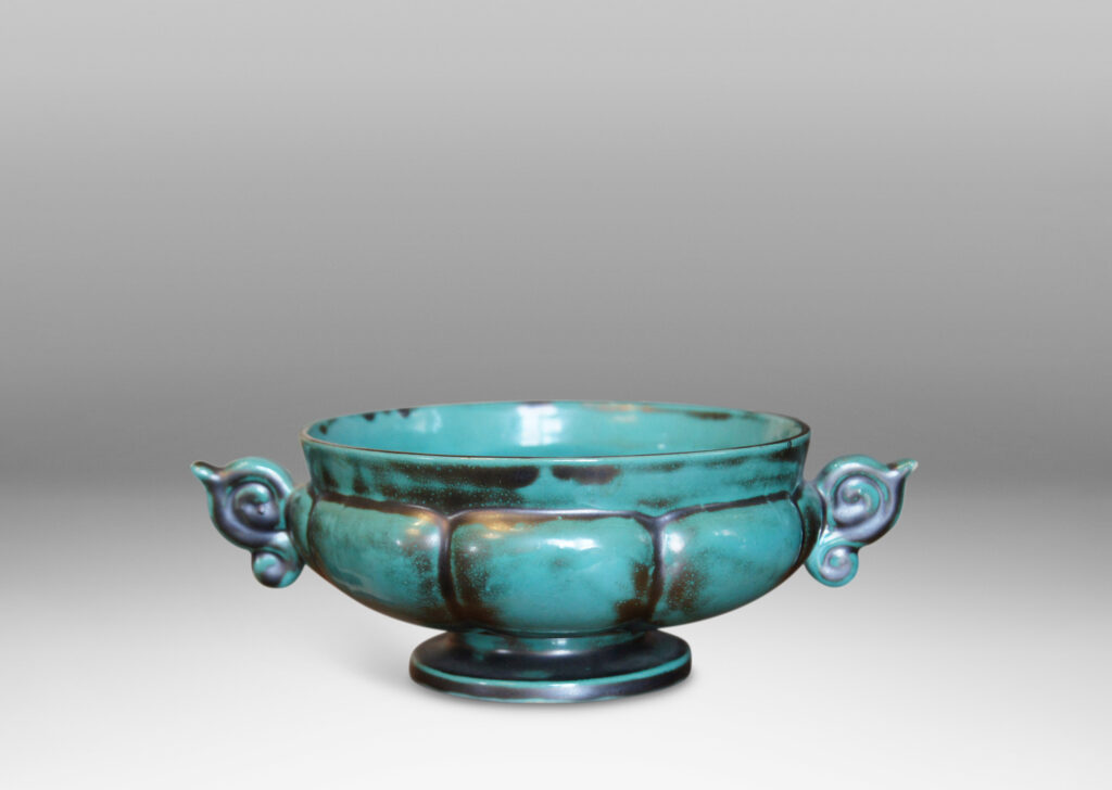 Gallery BAC blend of Viking, Chinese, and Art Deco influences, having wide lobed forms on small plinths and handles, faience with an aqua-green copper glaze