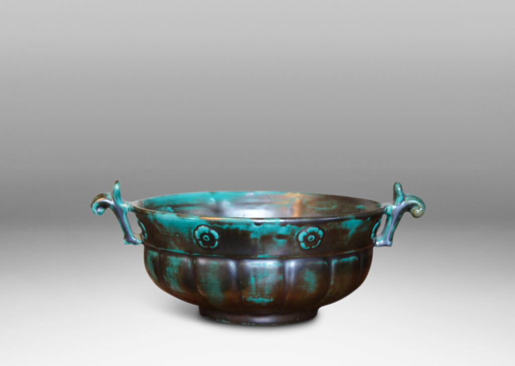 Gallery BAC blend of Viking, Chinese, and Art Deco influences, having wide lobed forms on small plinths and handles, faience with an aqua-green copper glaze