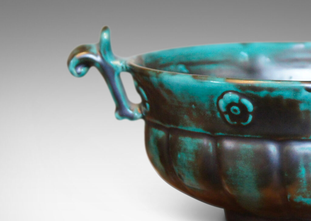 Gallery BAC blend of Viking, Chinese, and Art Deco influences, having wide lobed forms on small plinths and handles, faience with an aqua-green copper glaze