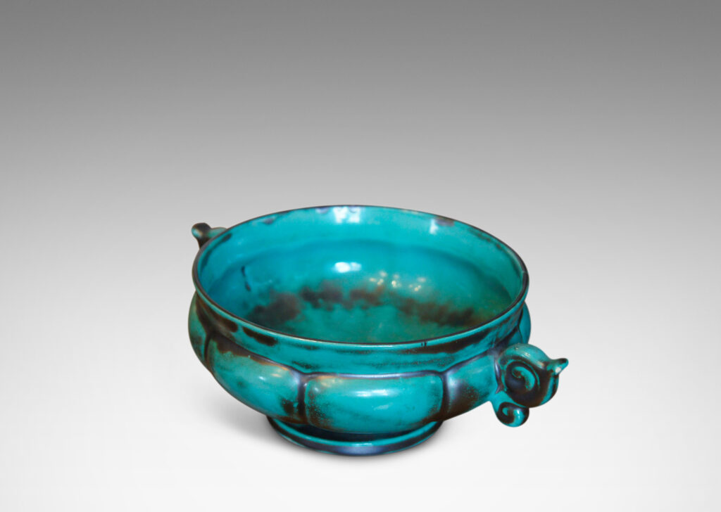 Gallery BAC blend of Viking, Chinese, and Art Deco influences, having wide lobed forms on small plinths and handles, faience with an aqua-green copper glaze