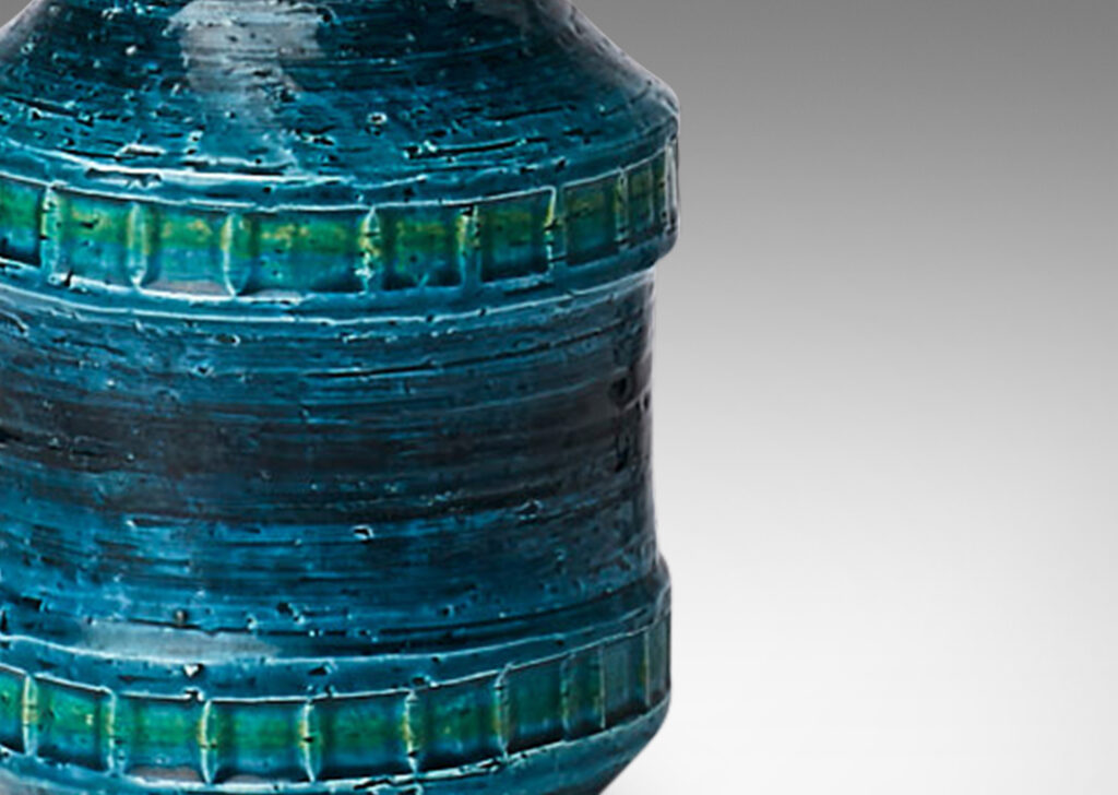 Gallery BAC bottle form with tall neck and impressed bands of squares in a saturated azure glaze