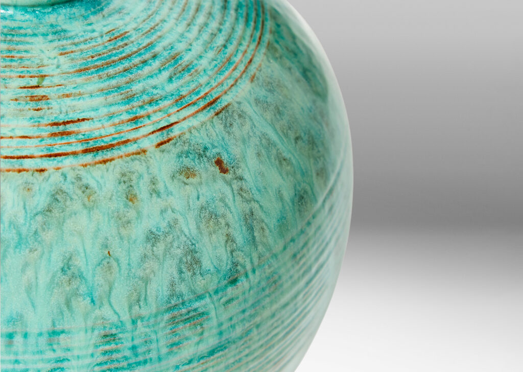 Gallery BAC wide globe form with bands of relief ridges in a flowing turquoise glaze