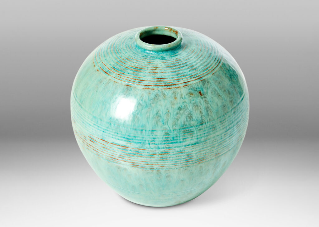 Gallery BAC wide globe form with bands of relief ridges in a flowing turquoise glaze