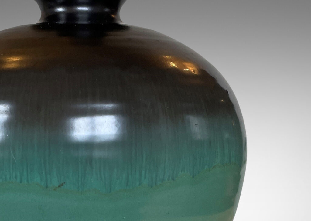 Gallery BAC globe form in blue-green and dark gray luster glazes