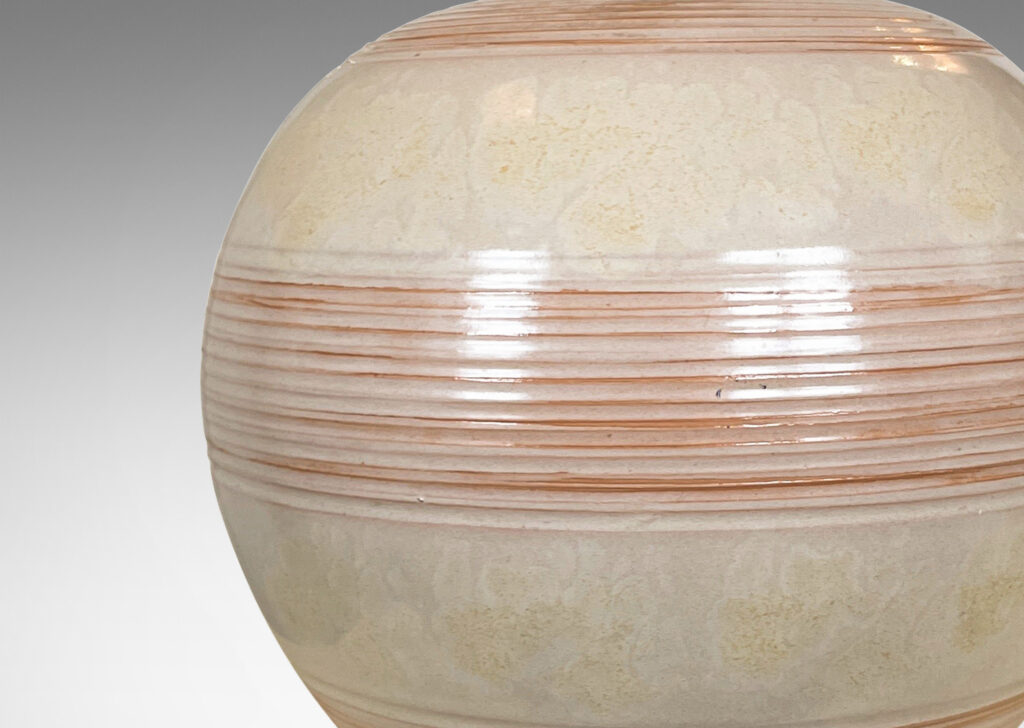 Gallery BAC plump globe form with ridged banding glazed in pale gray-tan with hints of terra cotta