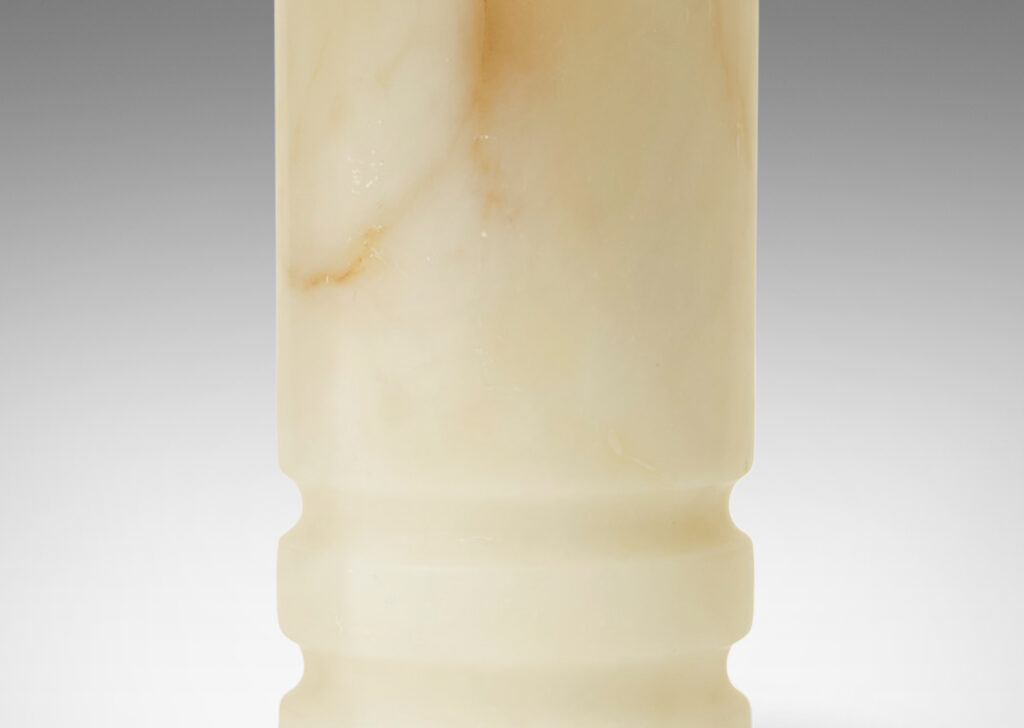 Gallery BAC column forms with lathed grooves on lower half for shadow interest; solid white onyx with brown veining