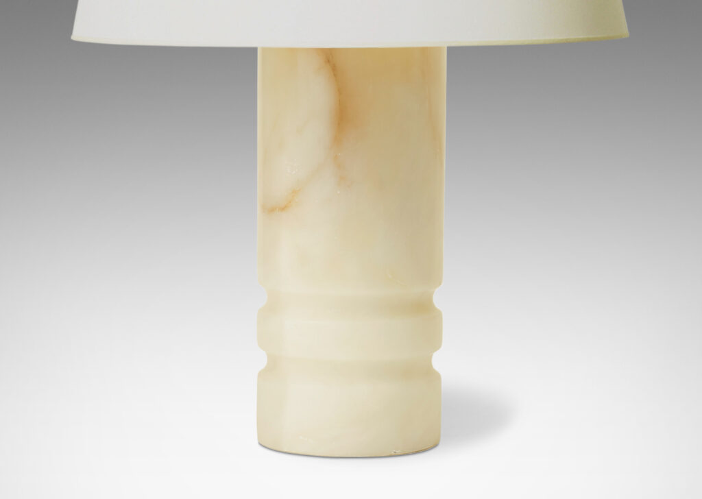 Gallery BAC column forms with lathed grooves on lower half for shadow interest; solid white onyx with brown veining