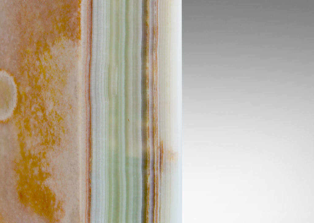 Gallery BAC square pillar bases in striated white, green and rose/rust-toned onyx