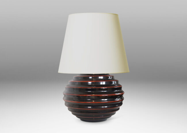 Gallery BAC wide globe form with deep and sculptural horizontal fluting and black glaze with scarlet pinstripes