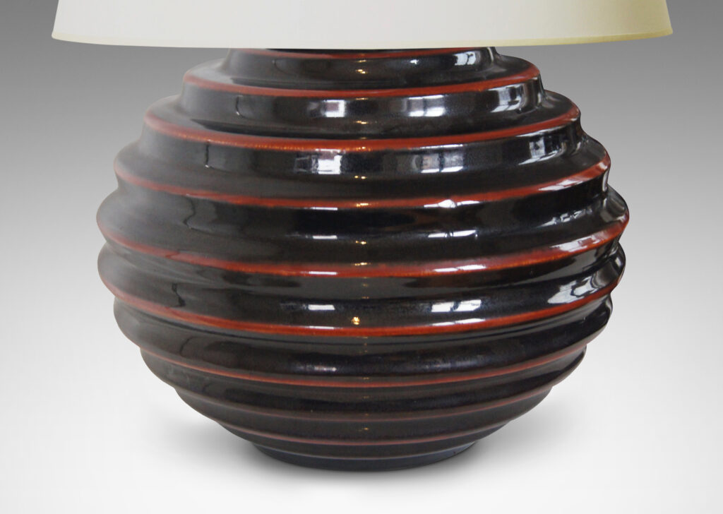 Gallery BAC wide globe form with deep and sculptural horizontal fluting and black glaze with scarlet pinstripes