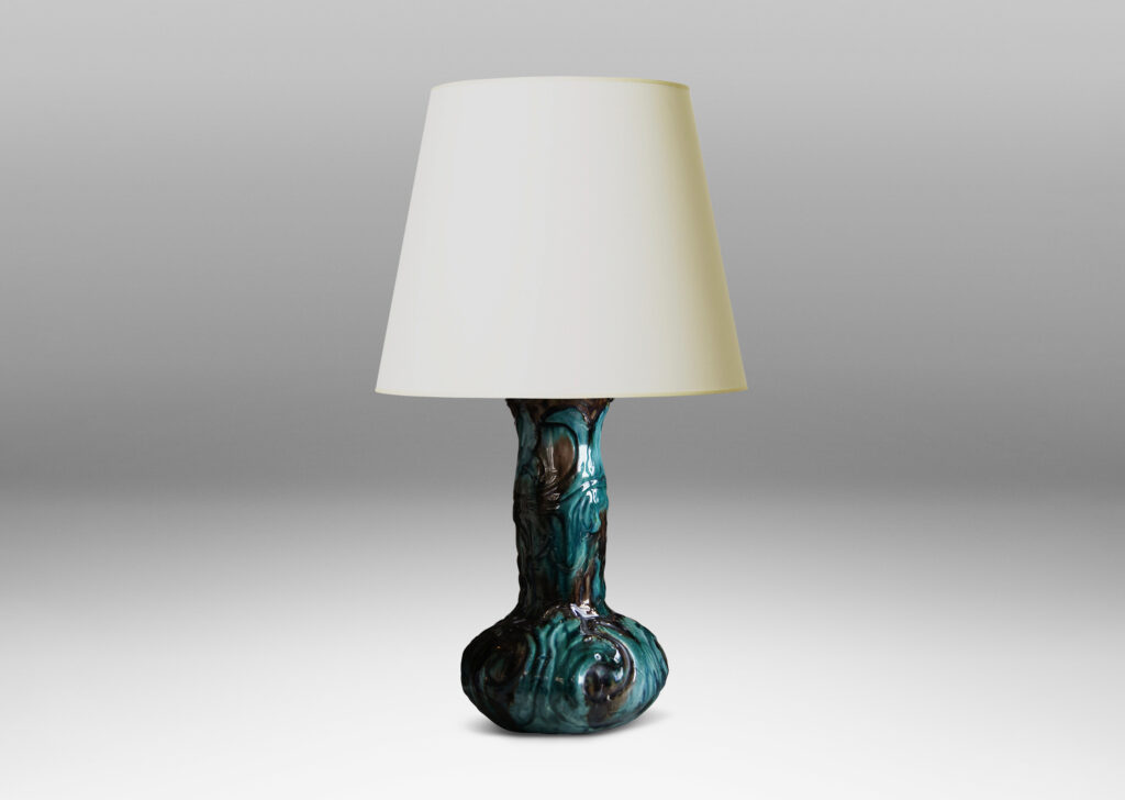 Gallery BAC decanter-like form with low wide body and tall neck, with carved swirling motifs in flowing teal and brown glazing