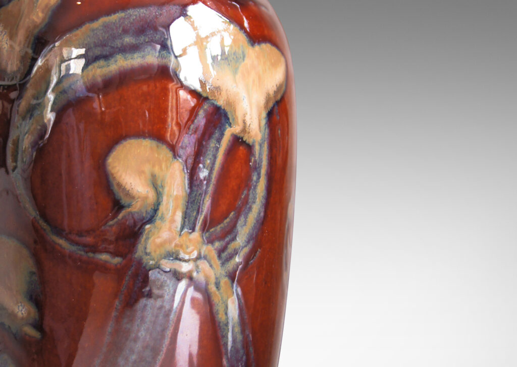 Gallery BAC vase form in a rich burnt sienna with scrolling pattern in pale taupe luster glaze