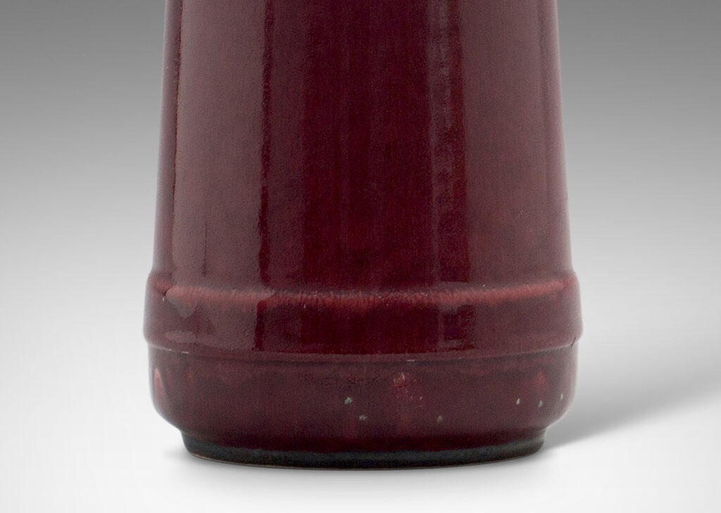 Gallery BAC angled bottle form in an oxblood glaze; stoneware