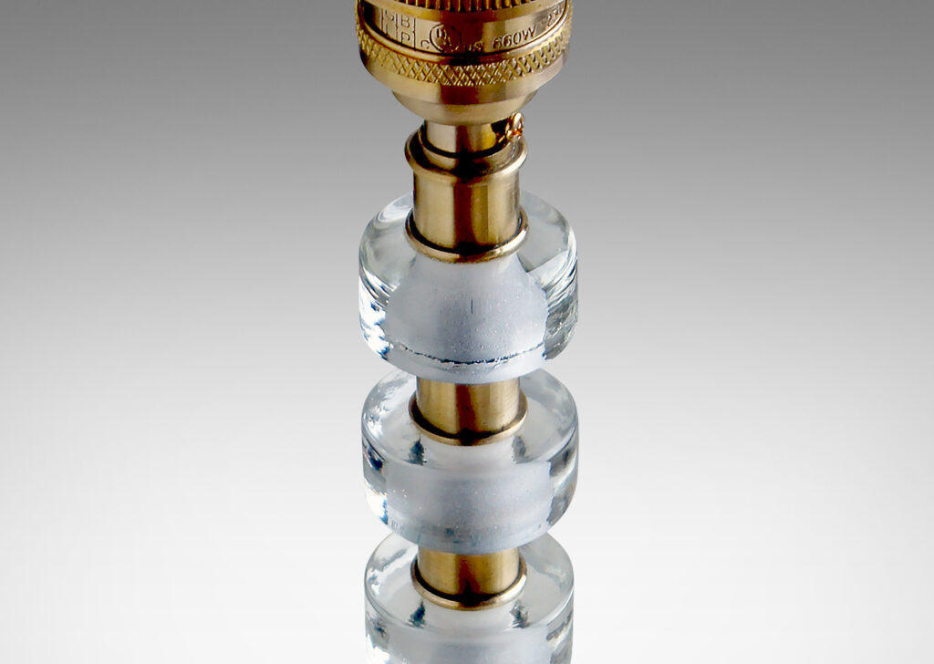 Gallery BAC stacked cast glass disks with brass spacers on a base with molded feet and swirling bottom texture