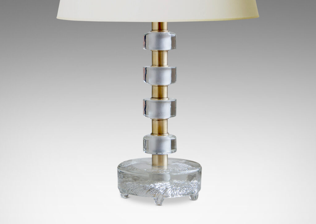 Gallery BAC stacked cast glass disks with brass spacers on a base with molded feet and swirling bottom texture