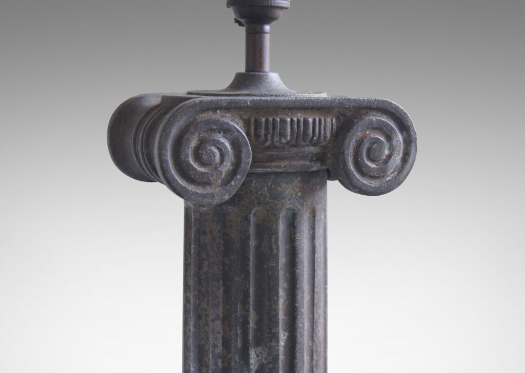 Gallery BAC all fluted Ionic column on a square plinth base edged in mitered molding, skillfully cast in iron with a mottled gray weathered finish