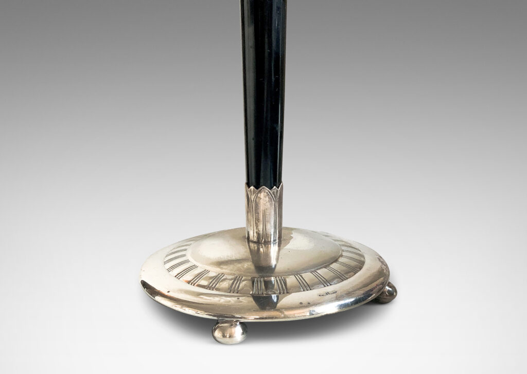 Gallery BAC tapered ebony stand with silvered disk base and cap ornamented with ribbed bands and lotus leaves