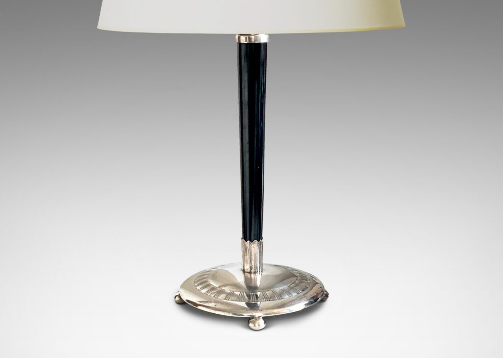 Gallery BAC tapered ebony stand with silvered disk base and cap ornamented with ribbed bands and lotus leaves