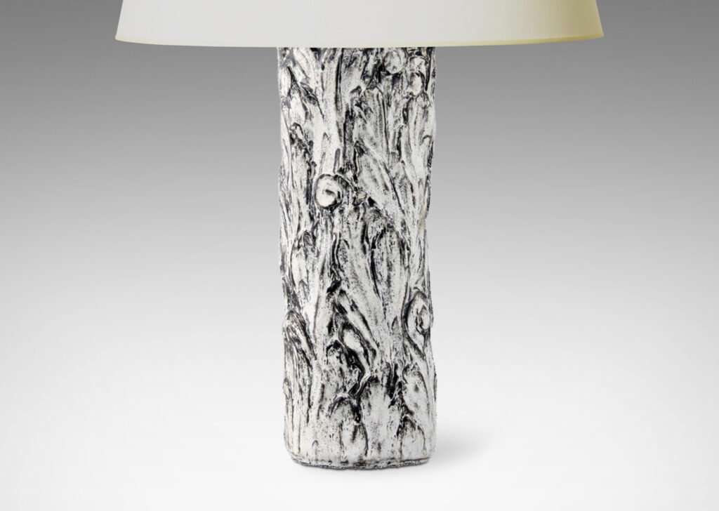 Gallery BAC columnar bases hand-carved with an energetic acanthus leaf pattern in deep relief, further articulated with a white-black tin glaze