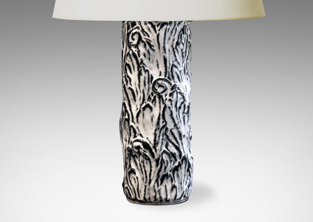 Gallery BAC columnar bases hand-carved with an energetic acanthus leaf pattern in deep relief, further articulated with a white-black tin glaze