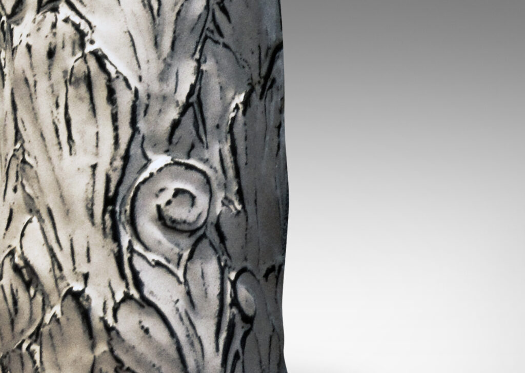 Gallery BAC columnar bases hand-carved with an energetic acanthus leaf pattern in deep relief, further articulated with a white-black tin glaze