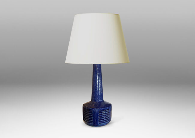 Gallery BAC low drum form with carved score patterning and tall neck glazed in a shiny saturated blue