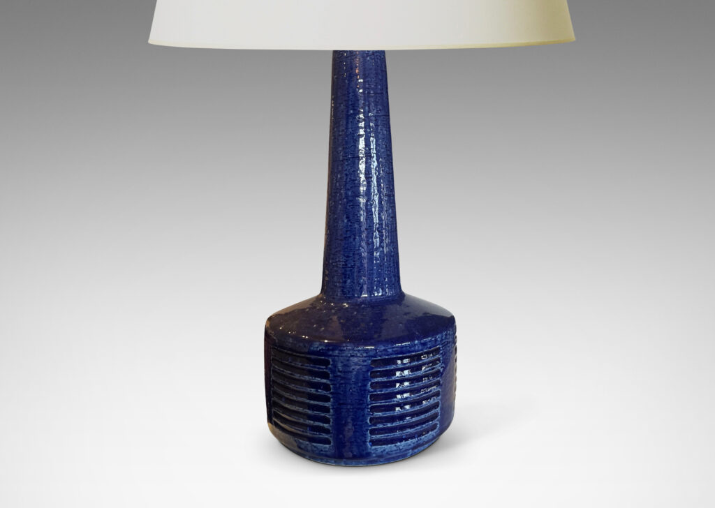 Gallery BAC low drum form with carved score patterning and tall neck glazed in a shiny saturated blue