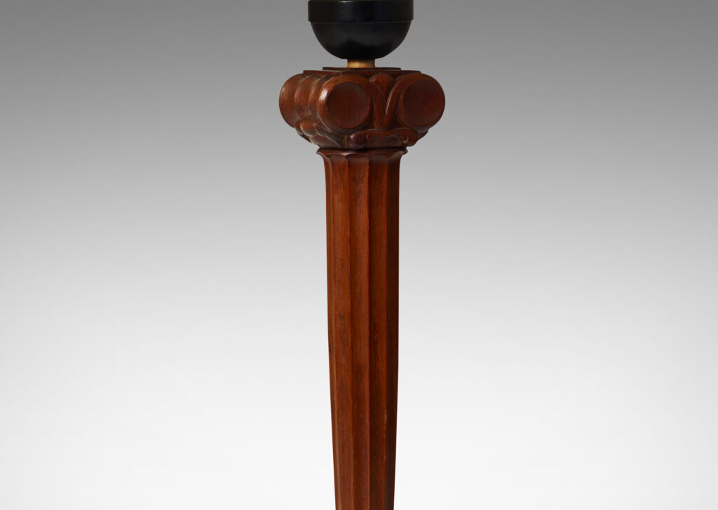 Gallery BAC base comprised of a lobed column capped with volutes, balanced on an ebonized wood sphere perched atop a round base sculpted in radiating planes mounted on a green marble disk