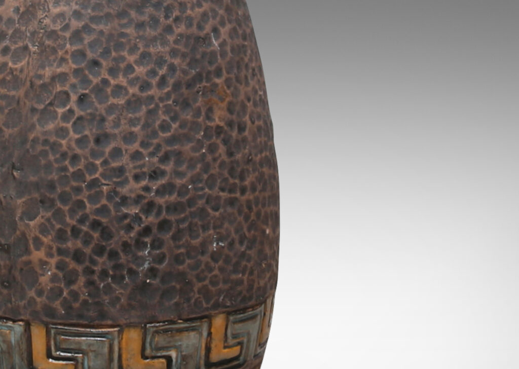 Gallery BAC bullet-like form with a carved dimpled pattern like hammered metal