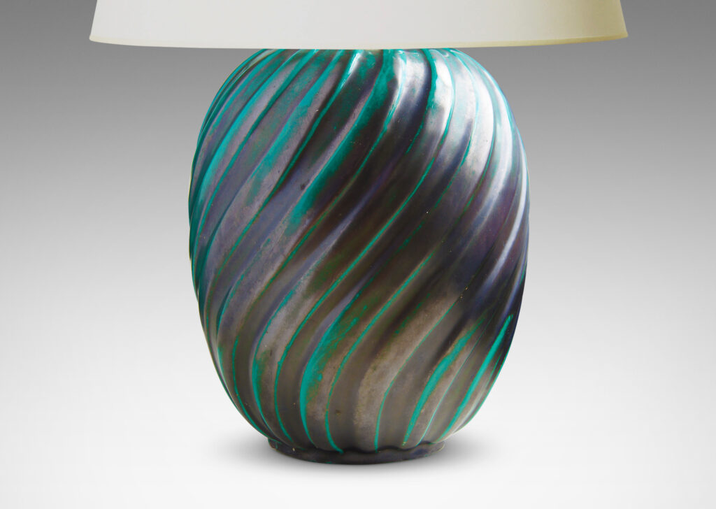 Gallery BAC ovoid form enveloped in a relief pattern of swirling flutes and a sumptuously deep-bluish green copper-oxide glaze