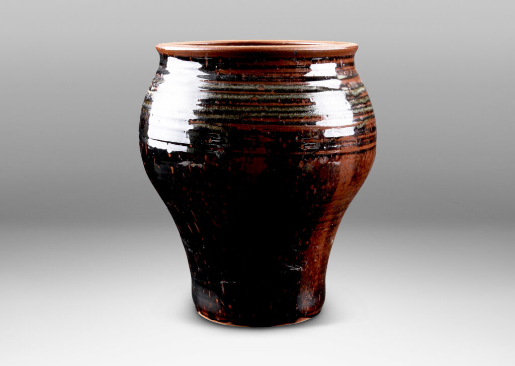 Gallery BAC welling form with turning ring texture, glazed in a black-red luster