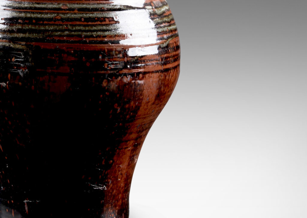 Gallery BAC welling form with turning ring texture, glazed in a black-red luster