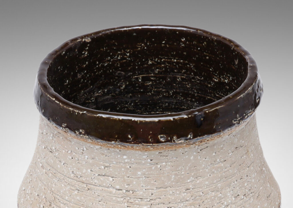 Gallery BAC wide low drum form with cove neck and mouth in grog stoneware, partially glazed in a dark chocolate brown