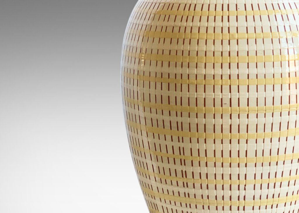 Gallery BAC tall tapering form with a magnificent basket-weave texture using glazing and sgraffito