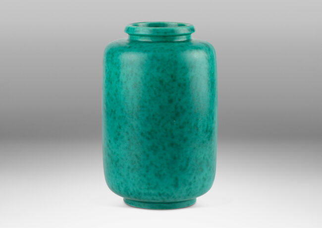 Gallery BAC rounded ends and notched neck/mouth and tray stand in a mottled blue-green copper oxide glaze