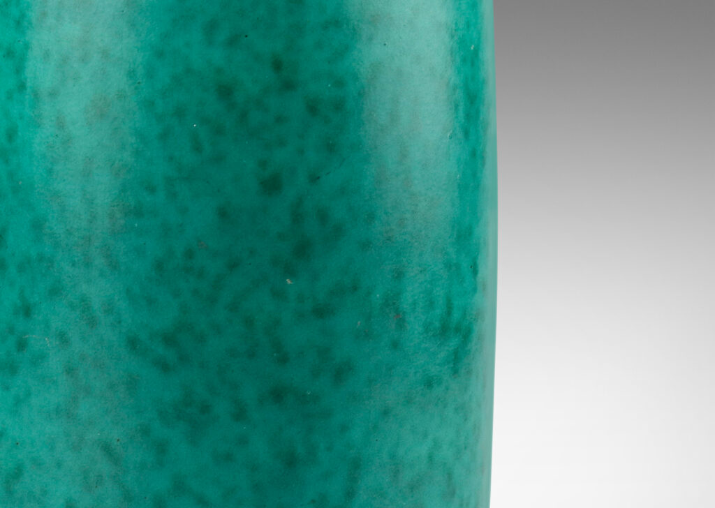 Gallery BAC rounded ends and notched neck/mouth and tray stand in a mottled blue-green copper oxide glaze