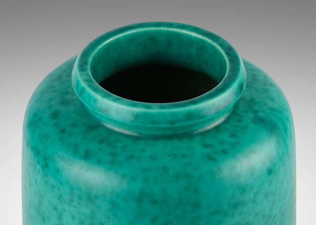 Gallery BAC rounded ends and notched neck/mouth and tray stand in a mottled blue-green copper oxide glaze