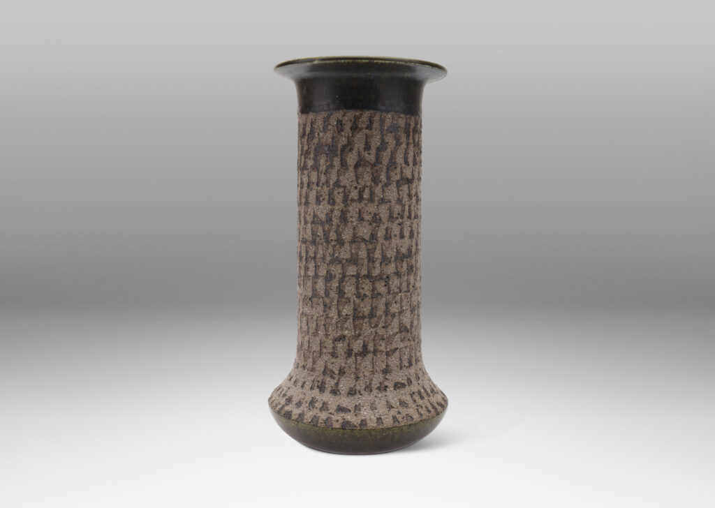 Gallery BAC columnar form with flared foot and flange lip, with a carved unglazed finish with green-gray glazed accents