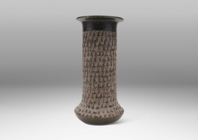 Gallery BAC columnar form with flared foot and flange lip, with a carved unglazed finish with green-gray glazed accents