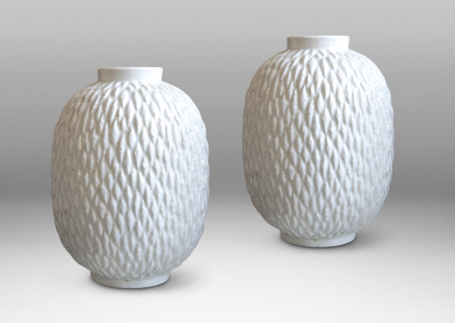 Gallery BAC ovoid bodies with carved lozenge pattern, crafted in flintware with crisp shiny white glaze