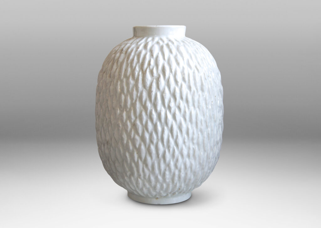 Gallery BAC ovoid bodies with carved lozenge pattern, crafted in flintware with crisp shiny white glaze