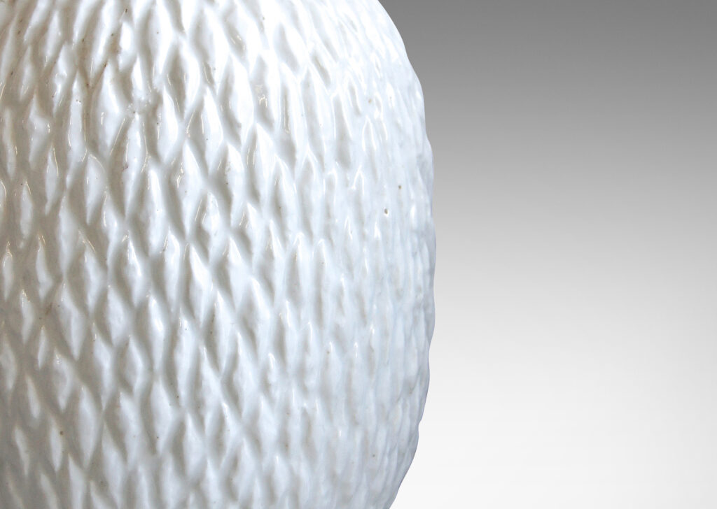 Gallery BAC ovoid bodies with carved lozenge pattern, crafted in flintware with crisp shiny white glaze