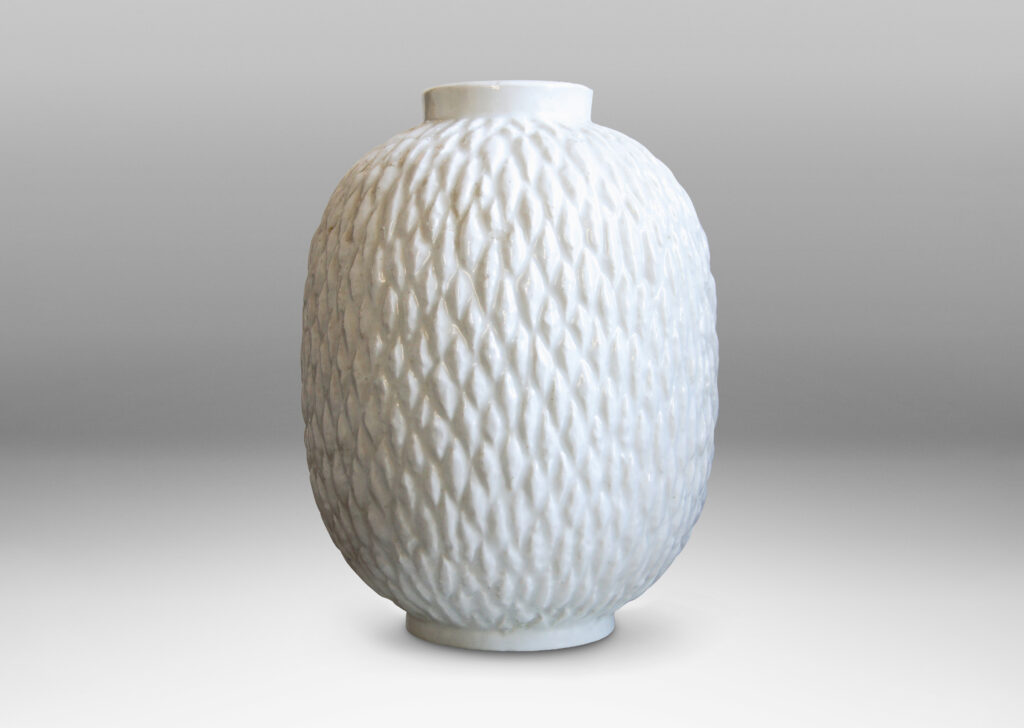 Gallery BAC ovoid bodies with carved lozenge pattern, crafted in flintware with crisp shiny white glaze