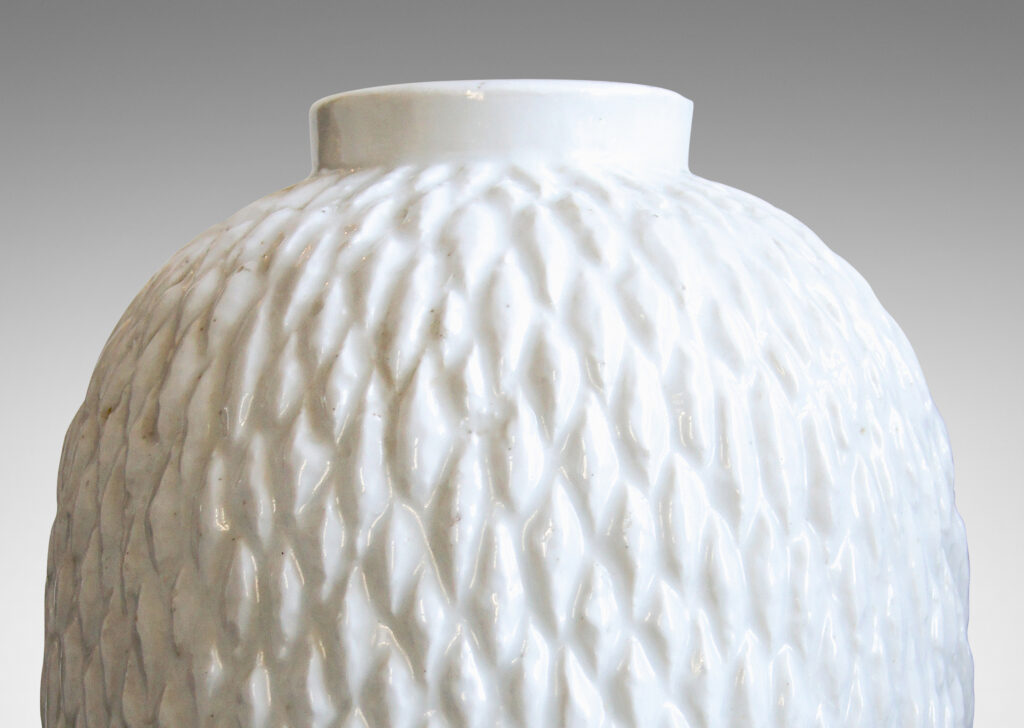 Gallery BAC ovoid bodies with carved lozenge pattern, crafted in flintware with crisp shiny white glaze