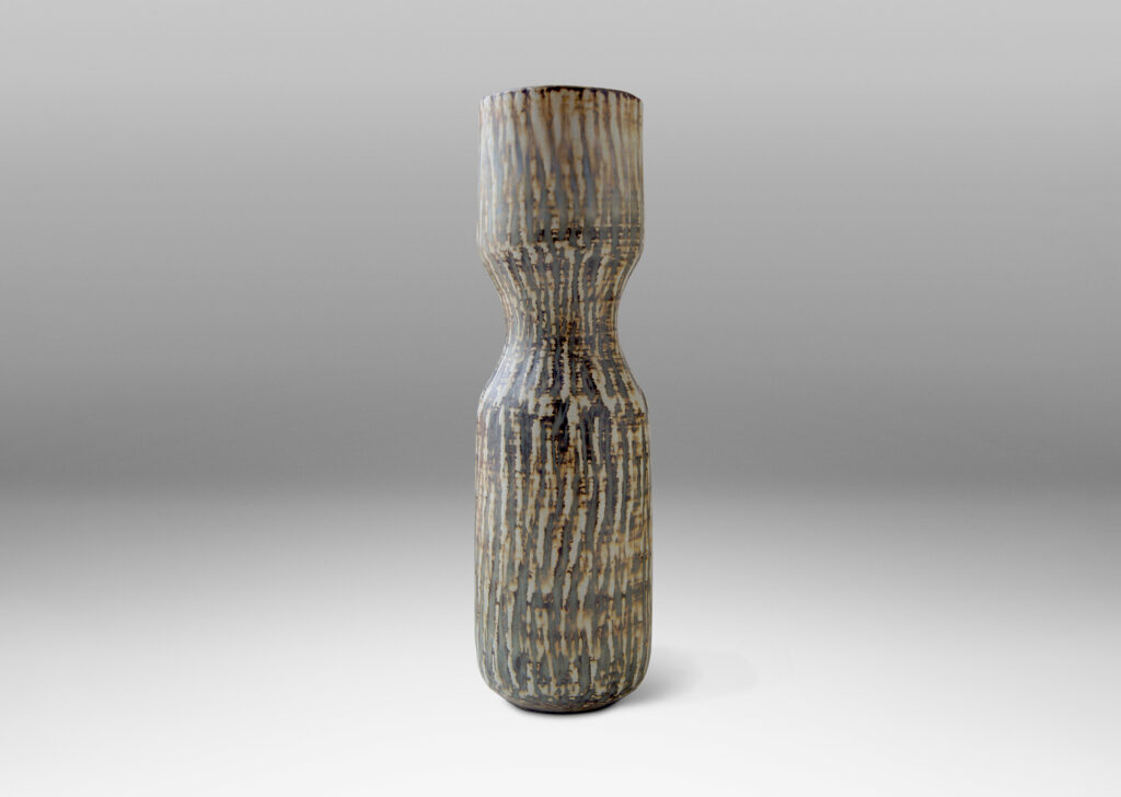 Gallery BAC slender hourglass form with a waist-like cinch and carved texture of diagonal hatches