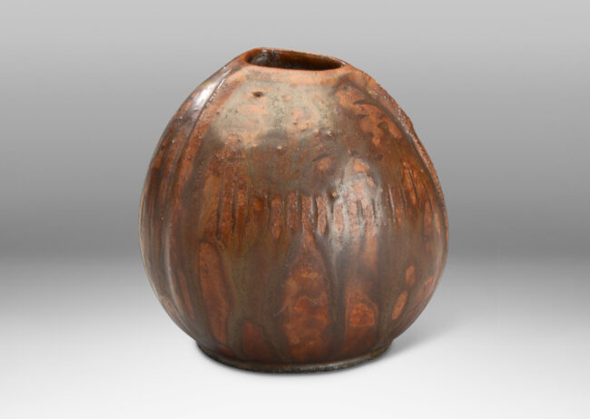 Gallery BAC ribbed bulbous form in earthenware with flowing brown glaze