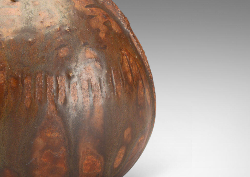 Gallery BAC ribbed bulbous form in earthenware with flowing brown glaze