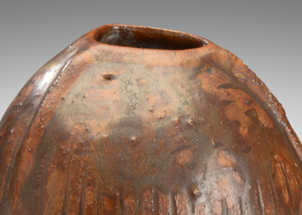 Gallery BAC ribbed bulbous form in earthenware with flowing brown glaze