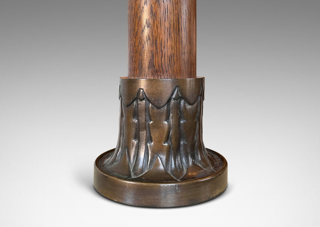 Gallery BAC cap and base decorated with stylized foliage in patinated bronze with a solid oak stand